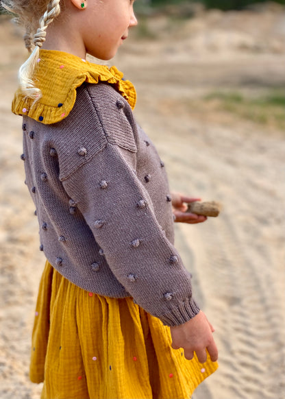 merino vilnos megztinis su bumbuliukais